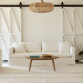 Modern living room with our Ayla Cream sofa, wooden coffee table, and decorative elements.